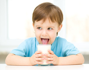 Image showing Cute little boy with a glass of milk