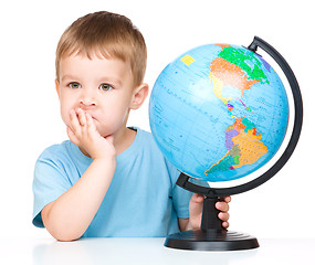 Image showing Little boy with a globe