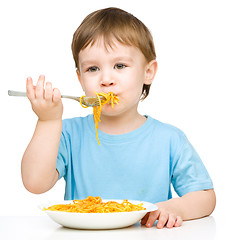 Image showing Little boy is eating spaghetti