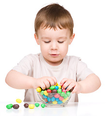 Image showing Portrait of a boy with candies