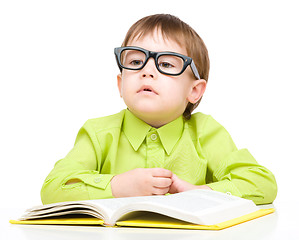 Image showing Little child play with book