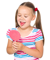 Image showing Little girl is going to lick her lollipop