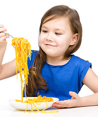 Image showing Little girl is eating spaghetti