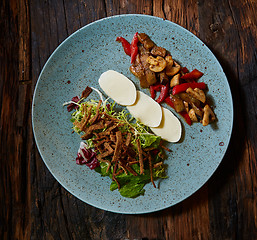 Image showing Rustic oven baked vegetables with spices and herbs in baking dish close up,