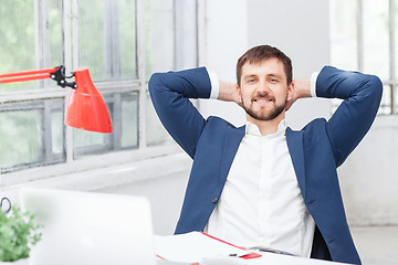 Image showing The male office worker resting