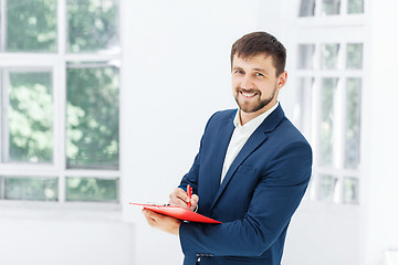 Image showing The smiling male office worker