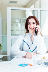 Image showing Woman doctor sitting at the table