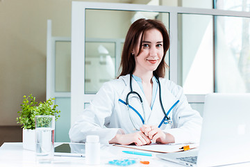 Image showing Woman doctor sitting at the table