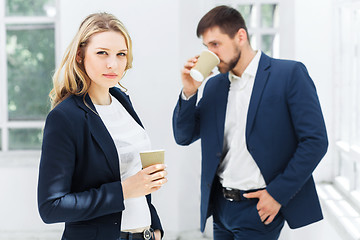 Image showing Young colleagues having coffee break in office