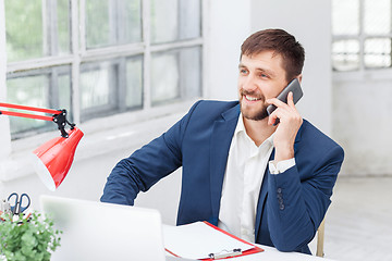 Image showing Portrait of businessman talking on phone in office