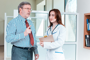 Image showing patient listening to his doctor in medical office