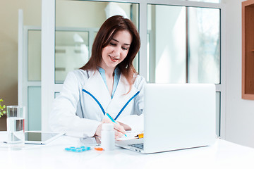 Image showing Woman doctor sitting at the table