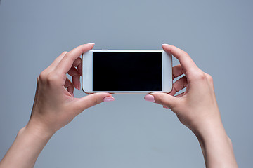 Image showing Closeup shot of a woman typing on mobile phone 