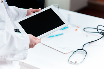 Image showing Doctor working on a digital tablet