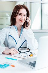 Image showing Woman doctor sitting at the table