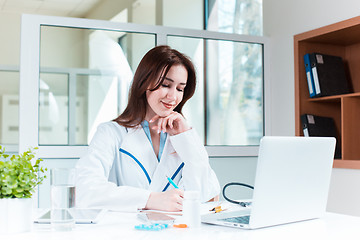 Image showing Woman doctor sitting at the table