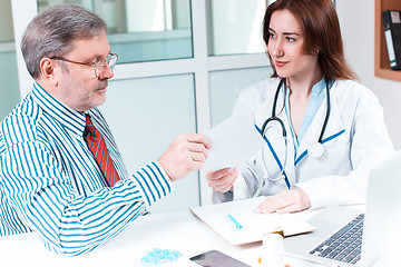 Image showing The patient and his doctor in medical office