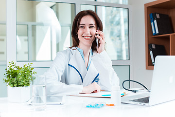 Image showing Woman doctor sitting at the table