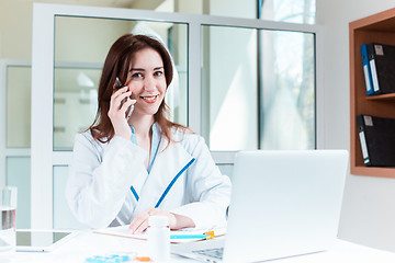 Image showing Woman doctor sitting at the table