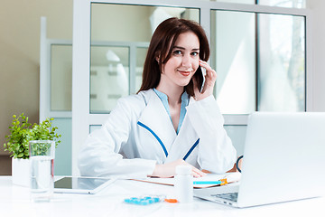 Image showing Woman doctor sitting at the table