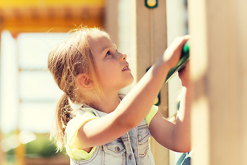 Image showing happy little girl climbing on children playground