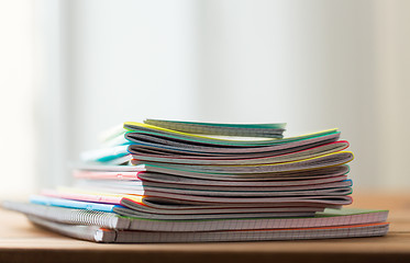 Image showing close up of notebooks on wooden table