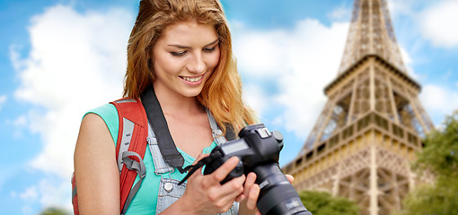 Image showing woman with backpack and camera over eiffel tower