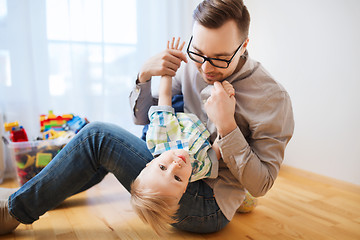 Image showing father with son playing and having fun at home