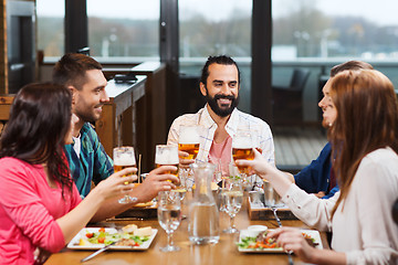 Image showing friends dining and drinking beer at restaurant