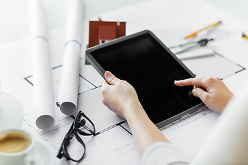 Image showing close up of hand with blueprint and tablet pc