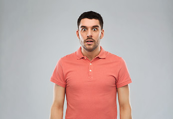 Image showing surprised man in polo t-shirt over gray background