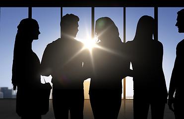 Image showing people silhouettes over office background