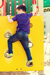 Image showing happy little boy climbing on children playground