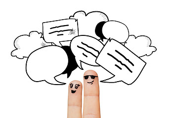 Image showing close up of two fingers with communication clouds