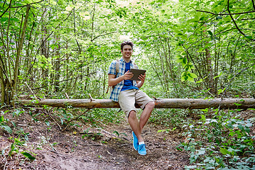 Image showing happy man with backpack and tablet pc in woods