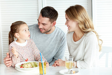 Image showing happy family having dinner at restaurant or cafe