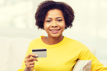 Image showing happy african woman with credit or debit card