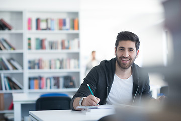 Image showing student in school library using laptop for research