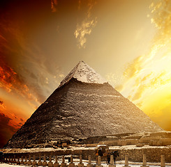 Image showing Fiery sunset and pyramid