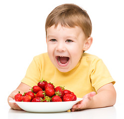 Image showing Happy little boy with strawberries