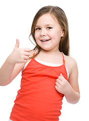 Image showing Little girl is showing thumb up gesture