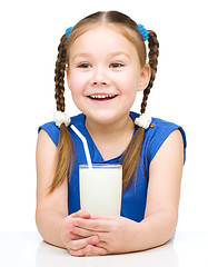 Image showing Cute little girl with a glass of milk