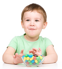 Image showing Portrait of a boy with candies