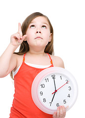 Image showing Little girl is holding big clock