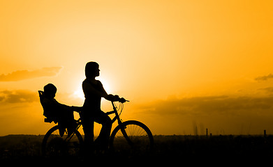 Image showing Mother riding on a bicycle with her child