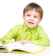 Image showing Little child play with book