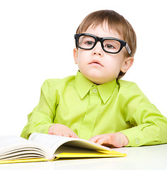 Image showing Little child play with book