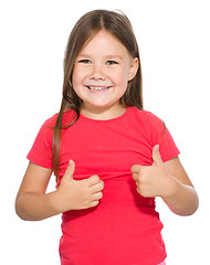 Image showing Little girl is showing thumb up gesture