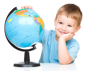 Image showing Happy little boy with a globe