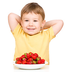 Image showing Happy little boy with strawberries